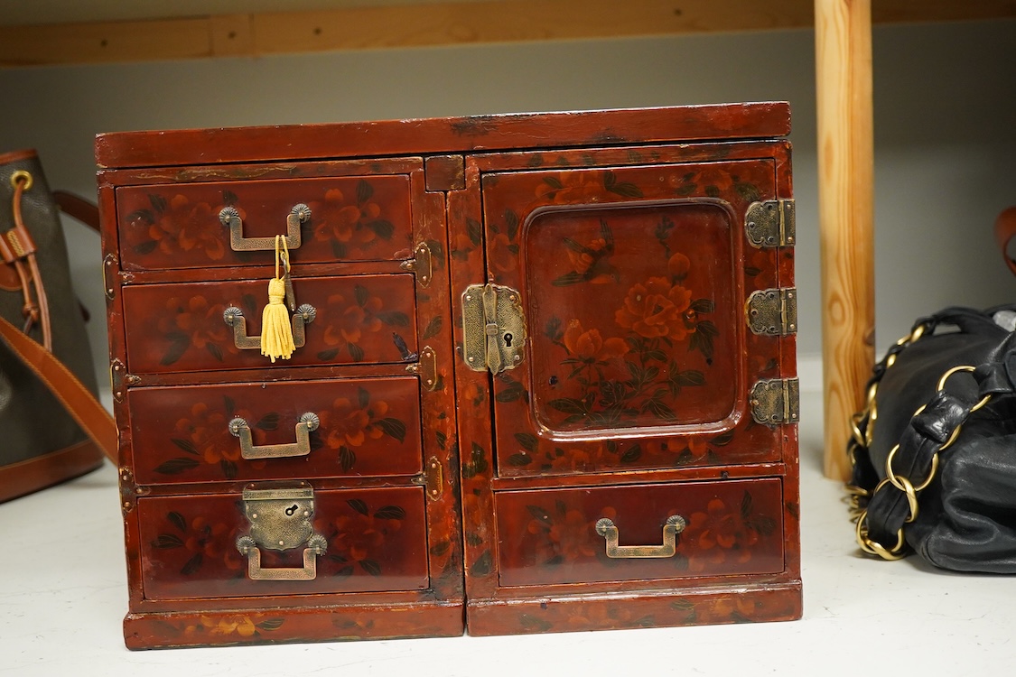 A Japanese floral lacquer table top cabinet, Taisho period, 36cm wide, the top panel is removable to form a twin pedestal cabinet